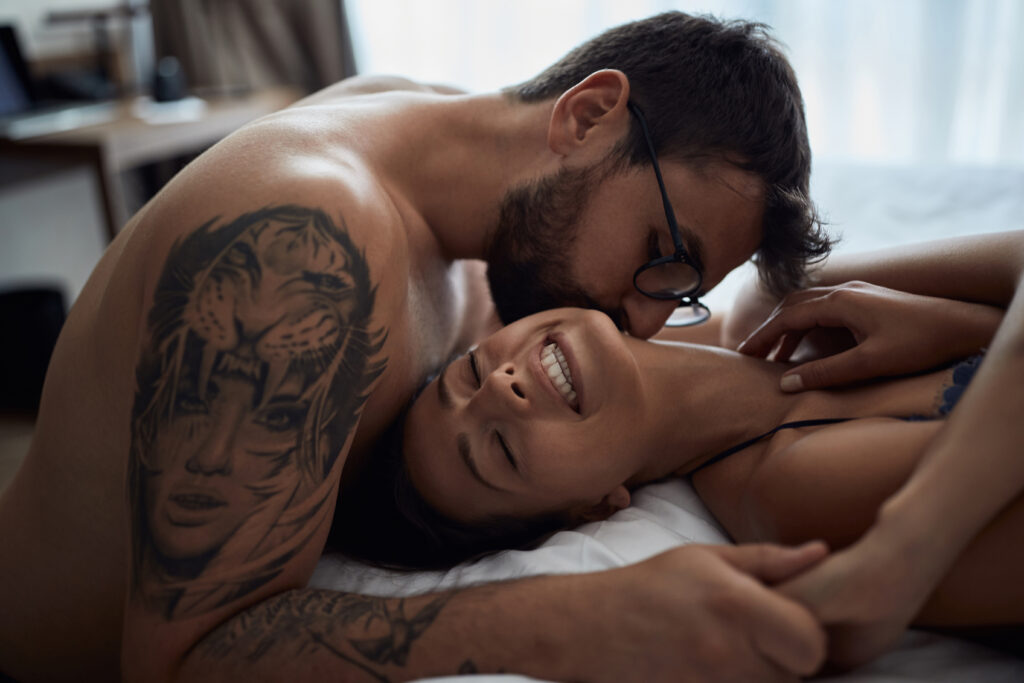 Tenderness in every touch. romantic couple in bedroom.